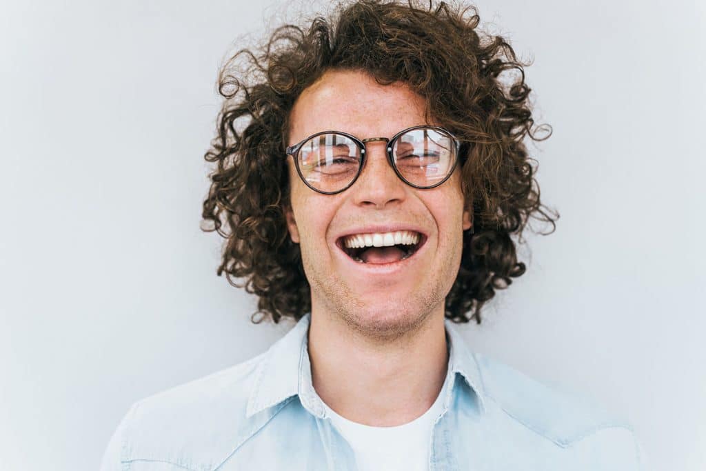 man with glasses smiling