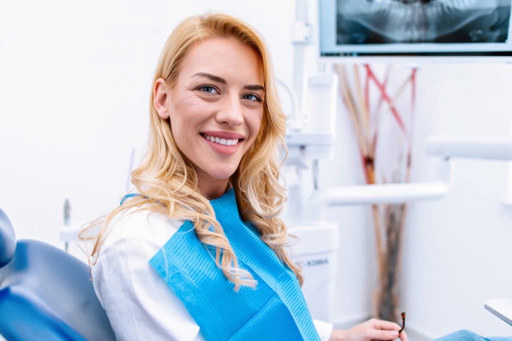 woman in dentist chair smiling
